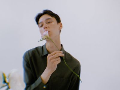 Person holding a focused, calm pose in a studio.